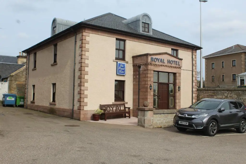 a car parked in front of a brick building at The Royal Hotel Elgin in Elgin