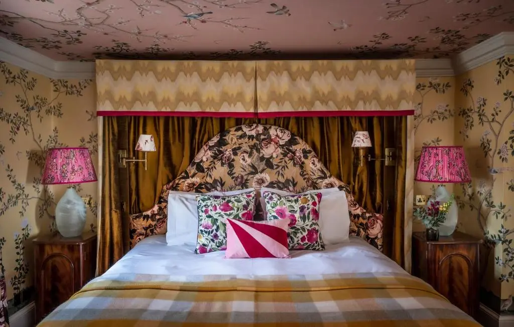 a bedroom with a bed with a headboard and pillows at The Glenmorangie House in Tain