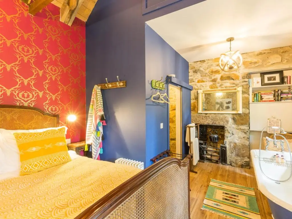a bedroom with a bed and a fireplace at Glamping Bothie in Inverurie