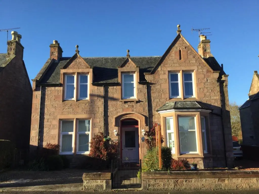 a large brick house with a front door at St Ann\u2019s Guest House in Inverness