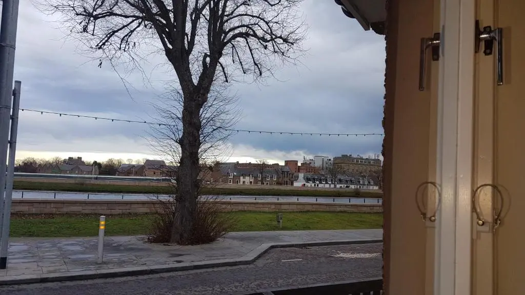 a view of a tree from a window at The Little House by the Ness in Inverness