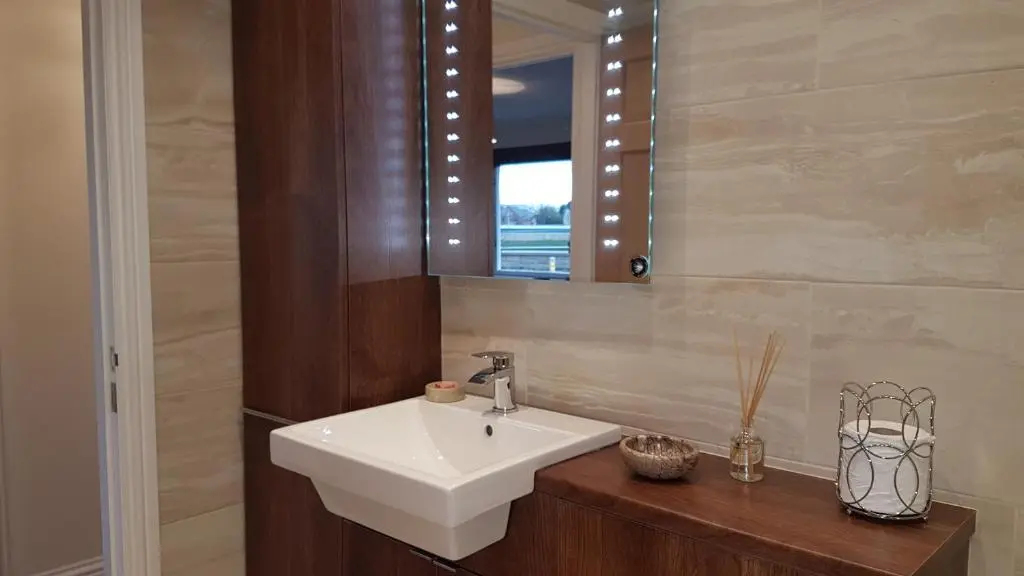 a bathroom with a white sink and a mirror at The Little House by the Ness in Inverness