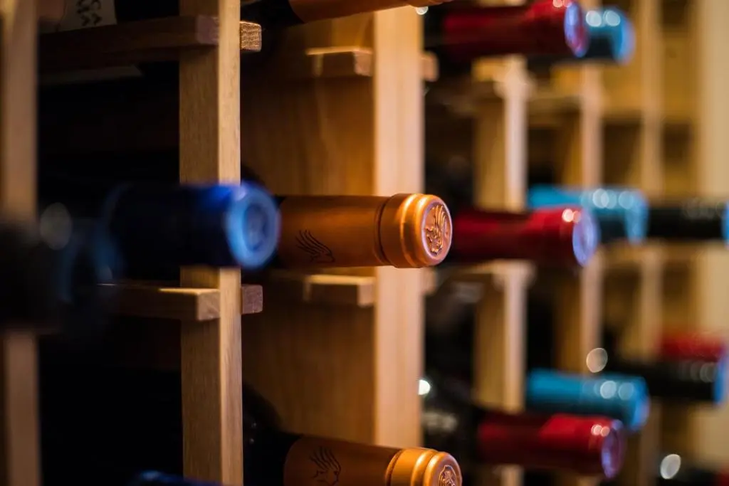 a bunch of bottles of wine on shelves at Douneside House in Tarland
