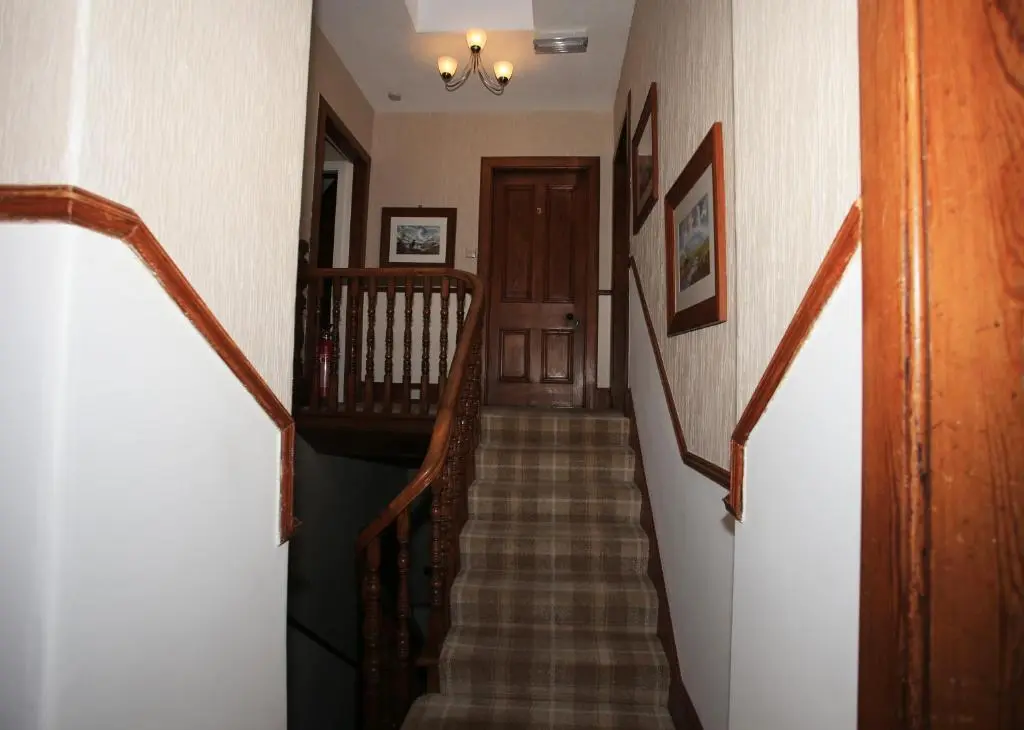 a hallway with a stairway with a staircase at Drumdale Bed and Breakfast in Inverness
