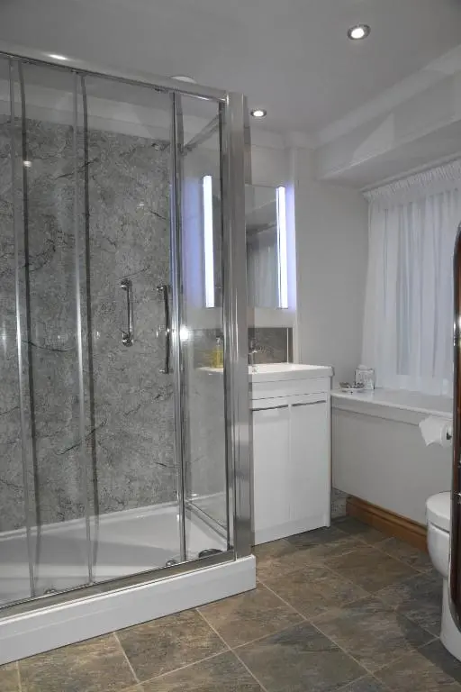 a bathroom with a glass shower and a toilet at Chapelhill Croft in Keith