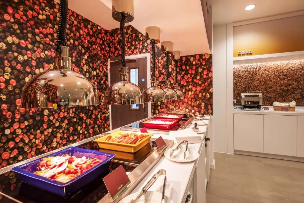 a kitchen with a bunch of food on a counter at Hampton By Hilton Aberdeen Airport in Dyce