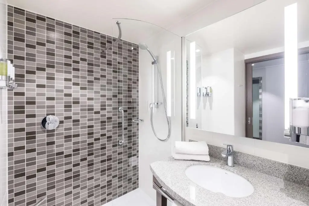 a bathroom with a sink and a shower at Hampton By Hilton Aberdeen Airport in Dyce