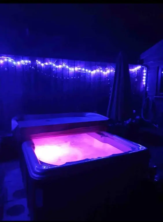 a hot tub in a dark room with lights at Bankhead Accommodation Aberdeenshire in Gamrie