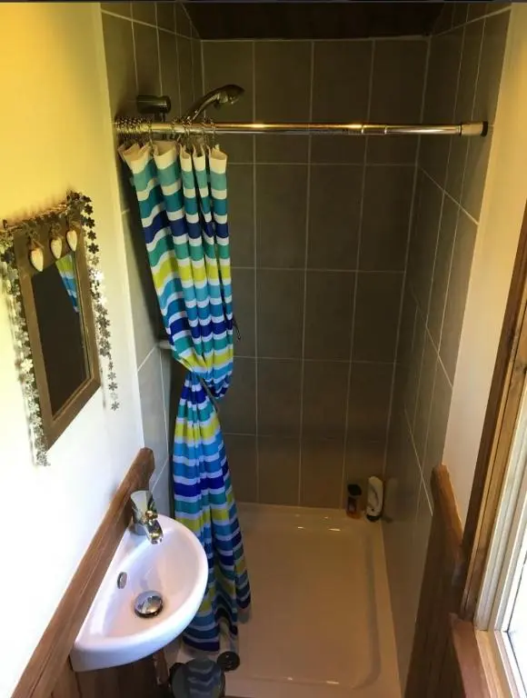 a bathroom with a tub and a sink and a shower at Bankhead Accommodation Aberdeenshire in Gamrie
