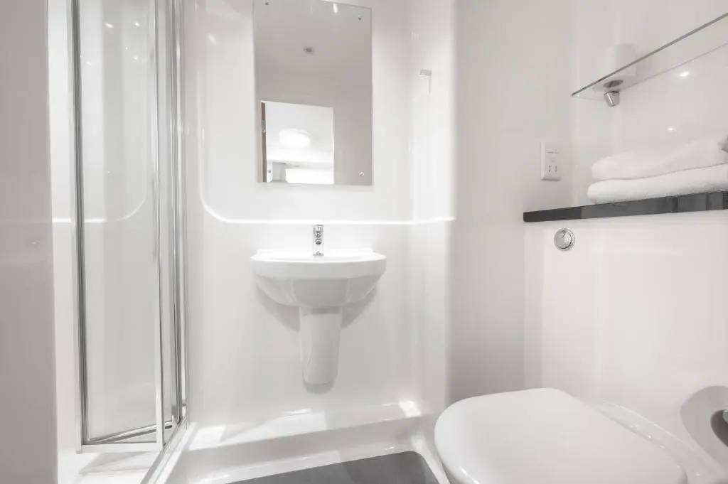a white bathroom with a toilet and a sink at UHI Inverness - Campus Accommodation in Inverness