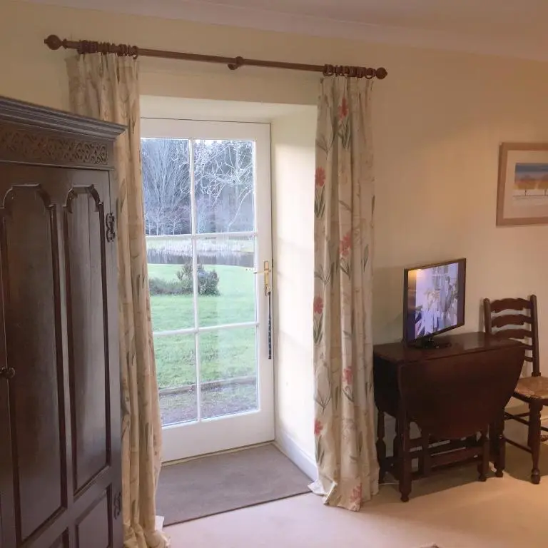 a door to a room with a window and a desk at The Annex - Easter Arr in Auldearn