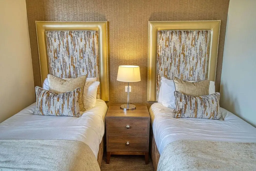 a hotel room with two beds and a lamp at Inverness Palace Hotel & Spa, WorldHotels Distinctive in Inverness