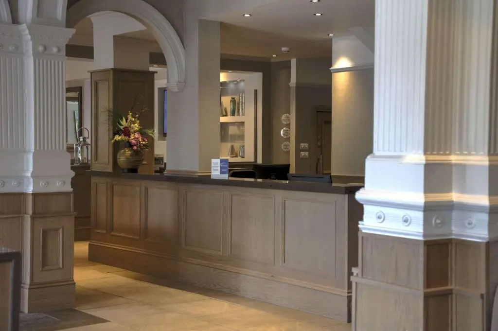 a lobby with a counter with flowers on it at Inverness Palace Hotel & Spa, WorldHotels Distinctive in Inverness