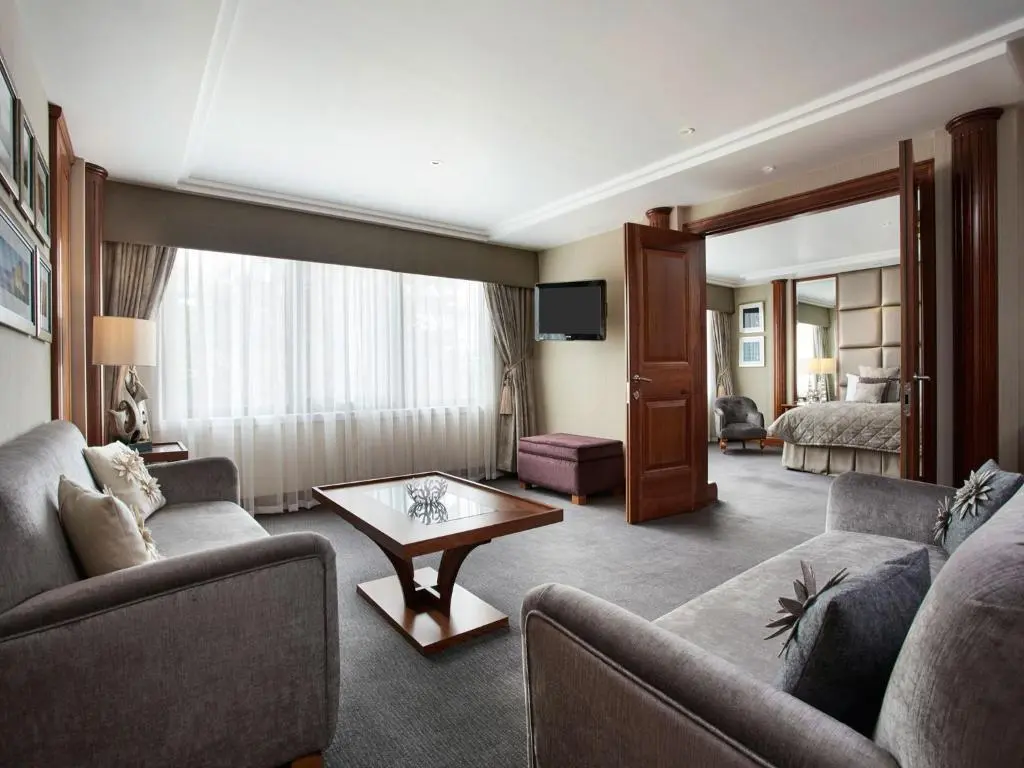a living room with a couch and a table at Leonardo Hotel and Conference Venue Aberdeen Airport in Dyce