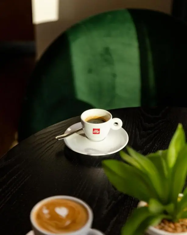 a cup of coffee sitting on top of a table at Leonardo Hotel Inverness in Inverness