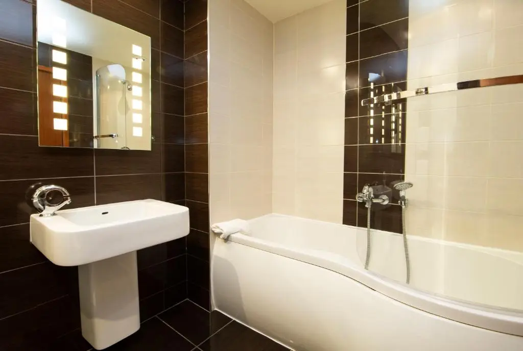 a bathroom with a sink and a bath tub at The Auld Kirk in Ballater