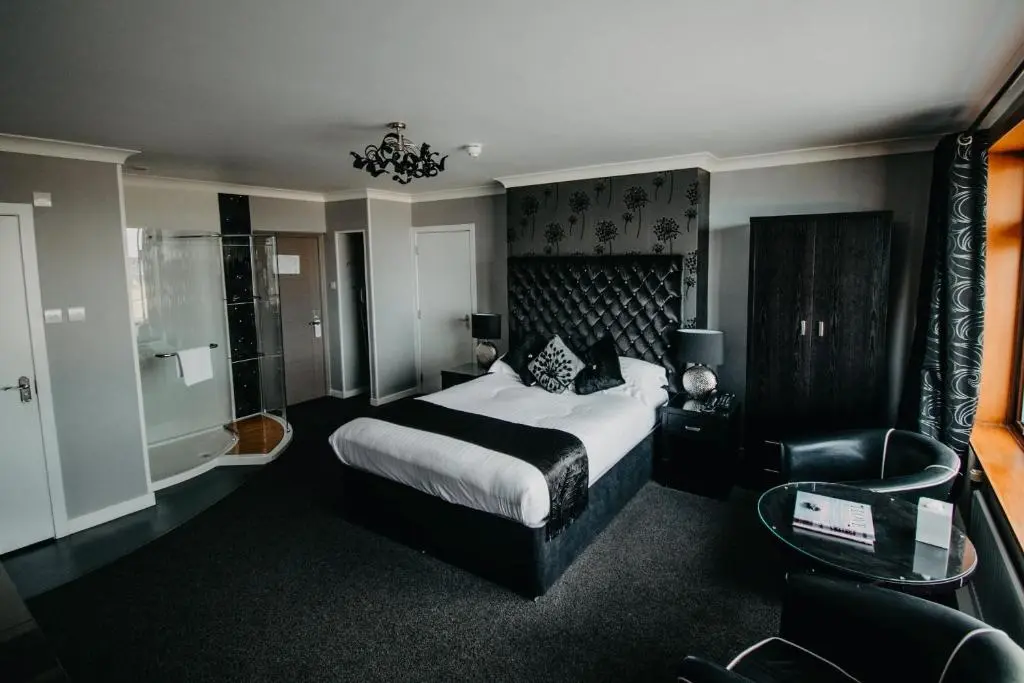 a hotel room with a bed and a chair at Banff Springs Hotel in Banff