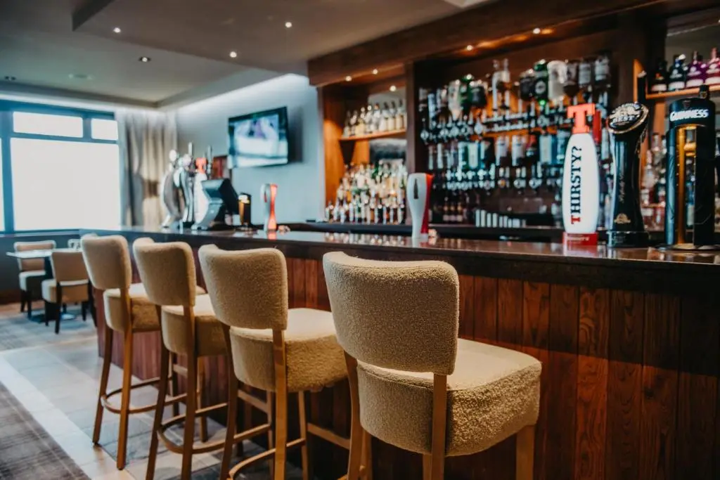 a bar with a row of stools in a restaurant at Banff Springs Hotel in Banff