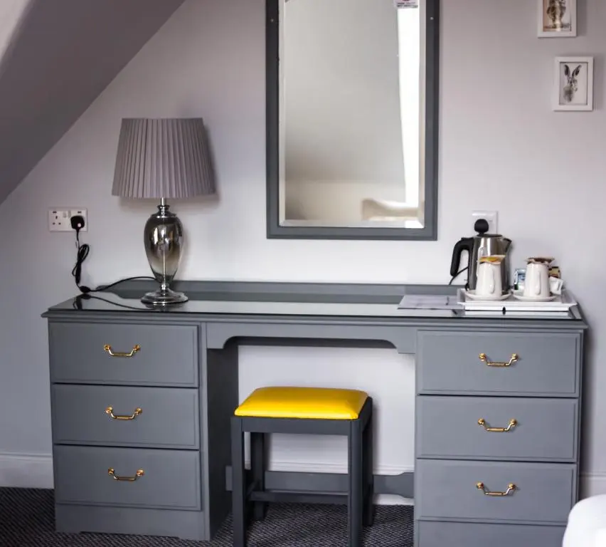 a desk with a chair and a lamp and a mirror at McInnes House rooms with breakfast in Kingussie