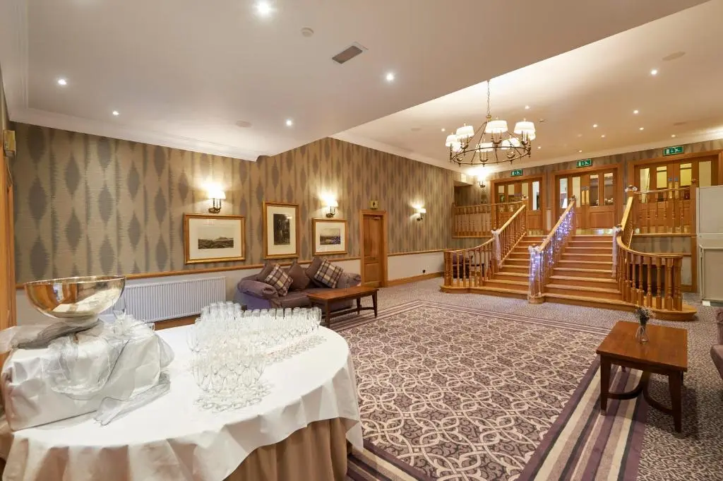 a large room with a table and some stairs at Macdonald Drumossie Hotel Inverness in Inverness