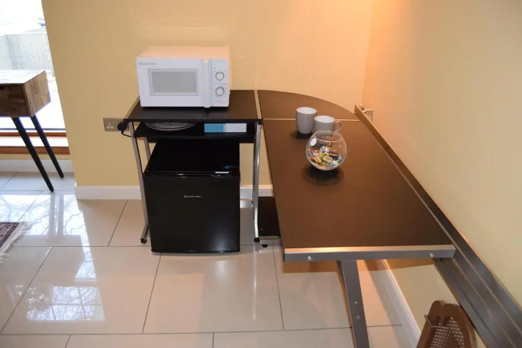 a kitchen with a table with a microwave on it at Amazing 4 Bed Scottish Baronial Style House in Westhill