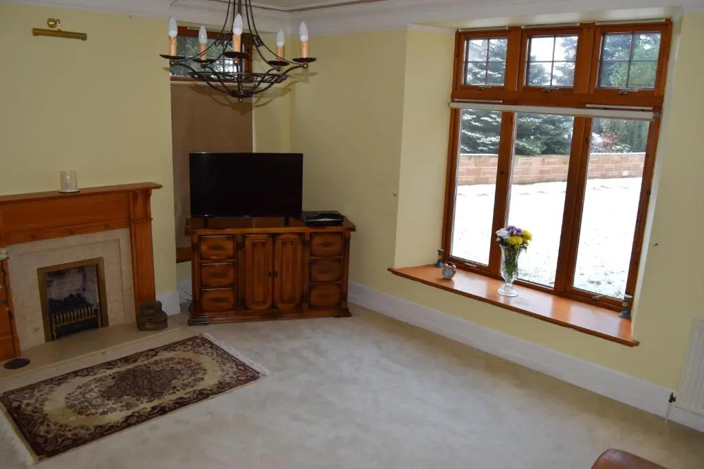 a living room with a television and a fireplace at Amazing 4 Bed Scottish Baronial Style House in Westhill