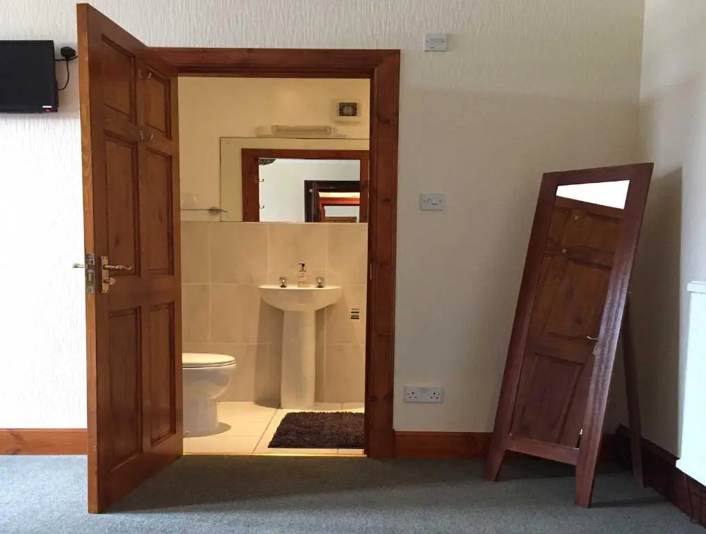 a bathroom with a toilet and a sink at Garfield Guesthouse in Dingwall