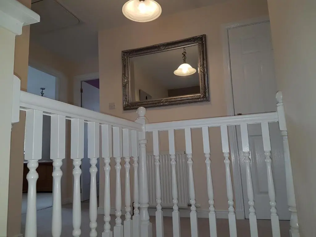 a white staircase with a mirror on the wall at Jane's Villa Free Parking in Inverness