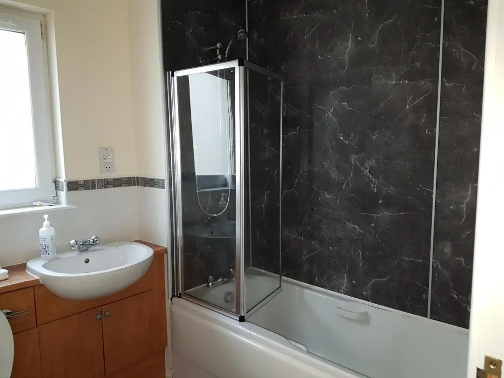 a bathroom with a shower and a sink at Jane's Villa Free Parking in Inverness