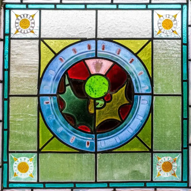 a stained glass window with a plate in the middle at Washington House in Nairn