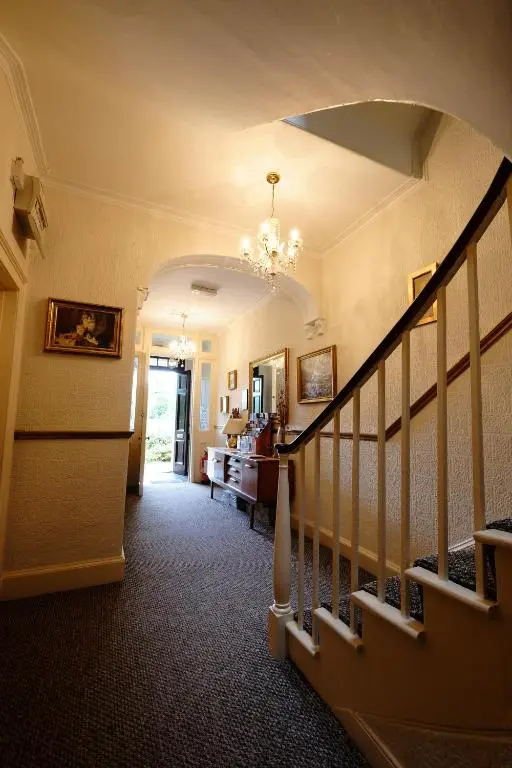 a hallway with a staircase in a house at Talisker Guest House in Inverness