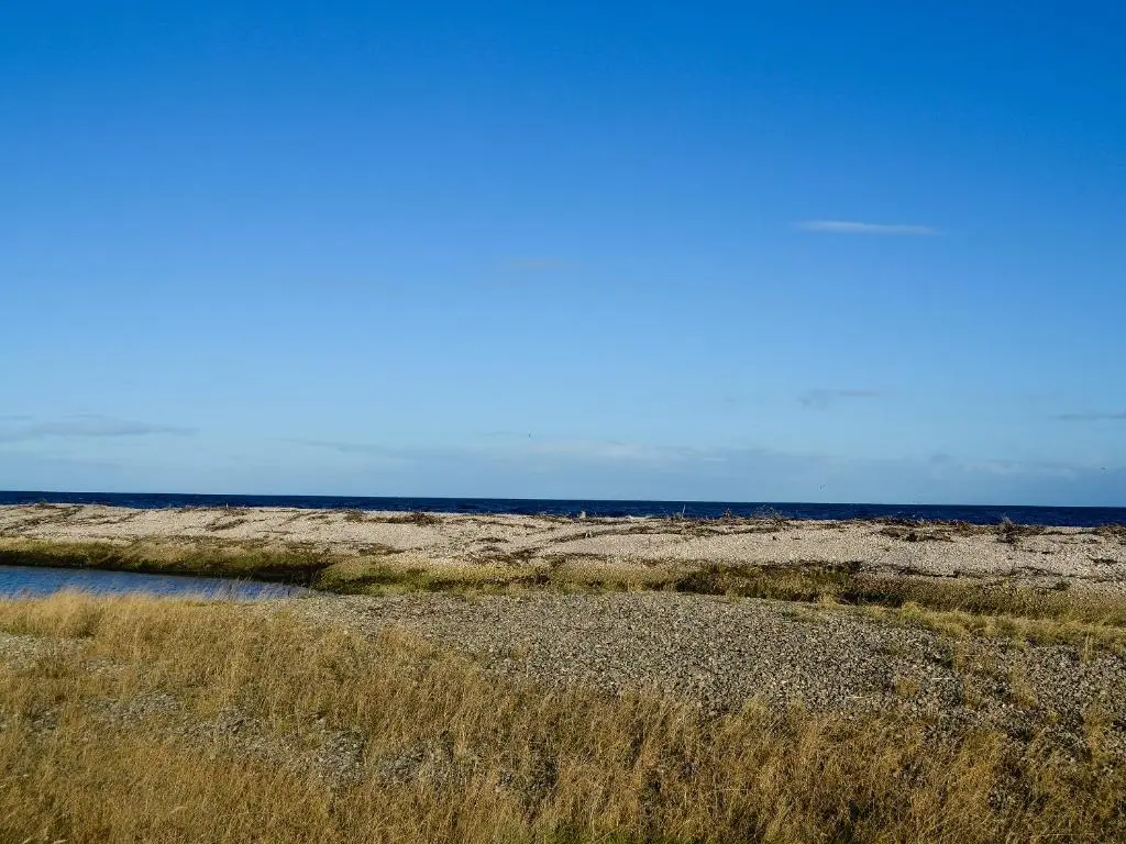 an empty field with the ocean in the background at Firth View in Garmouth
