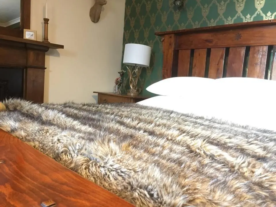 a bedroom with a bed with a zebraskin at Balsporran Bed And Breakfast in Dalwhinnie