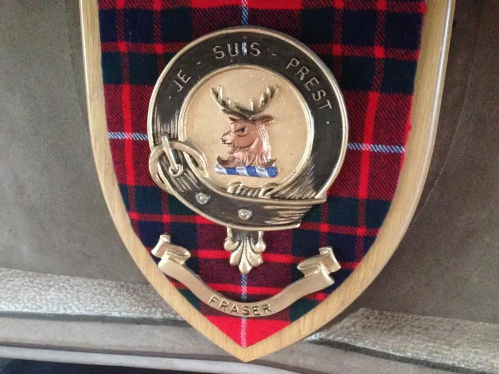 a medal with a picture of a deer on it at Highland Bear Lodge & Luxury Bear Huts in Drumnadrochit