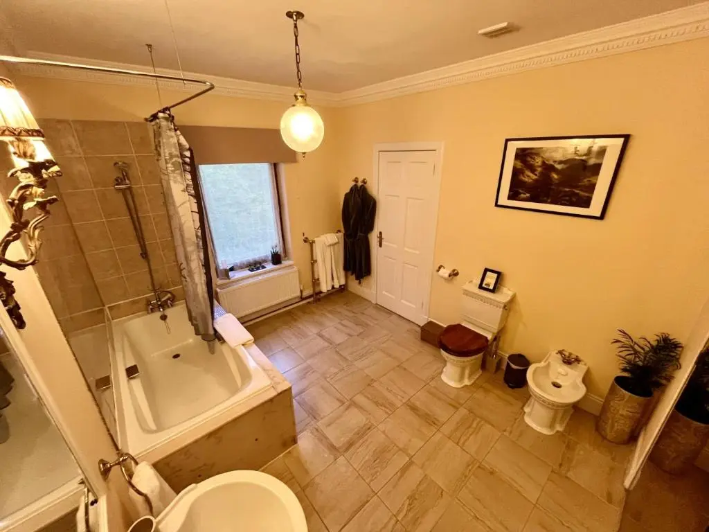 a bathroom with a tub and a toilet and a sink at Highland Bear Lodge & Luxury Bear Huts in Drumnadrochit