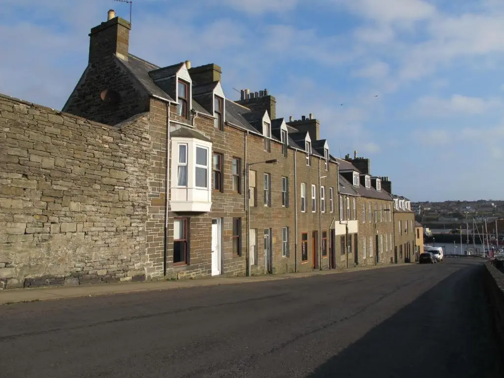 a large brick building on the side of a street at House by the Harbour - NC500 Route in Wick