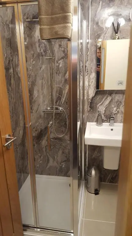 a bathroom with a shower and a sink at Star Inn Rooms in Ardersier