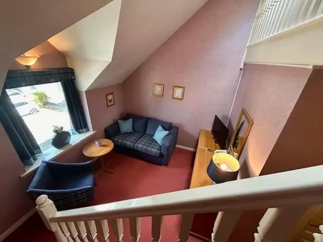 a living room with a couch and a table at The Craighaar Hotel in Aberdeen