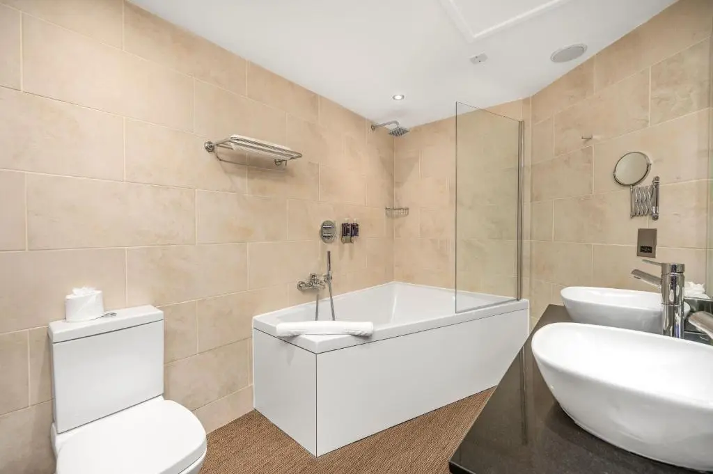 a bathroom with a white toilet and a sink at Rocpool Reserve in Inverness