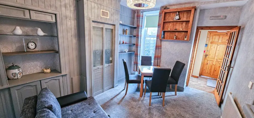 a room with a table and chairs and a dining room at mySTAYINN Kinloch Lodge in Inverness
