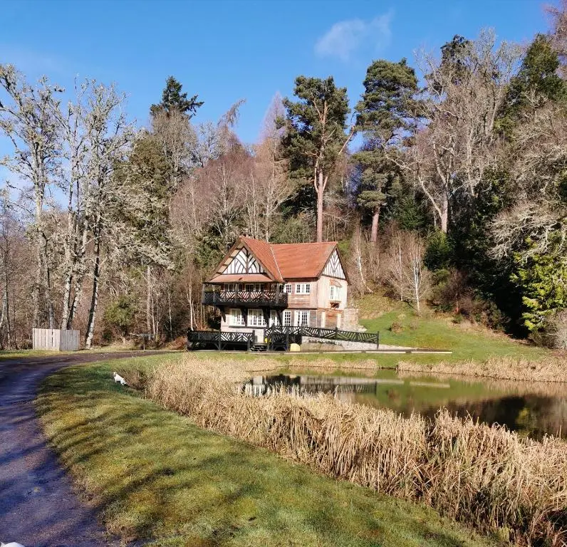 a house on a hill next to a lake at Hillhaven Bed &Breakfast in Fortrose