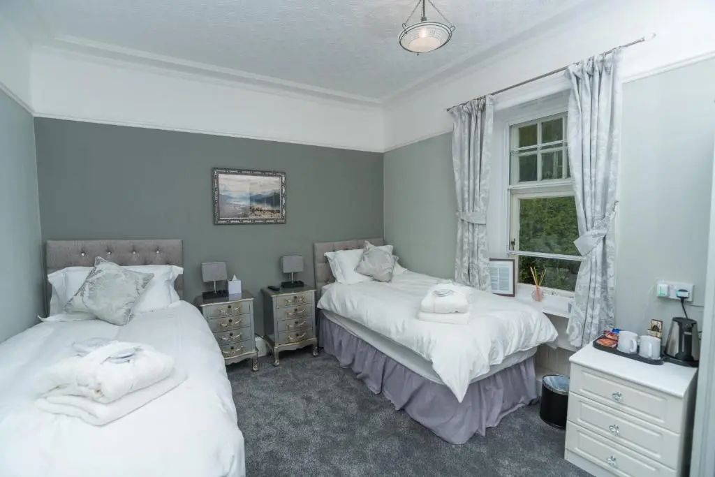 a bedroom with two beds and a window at Foyers Bay Country House in Foyers