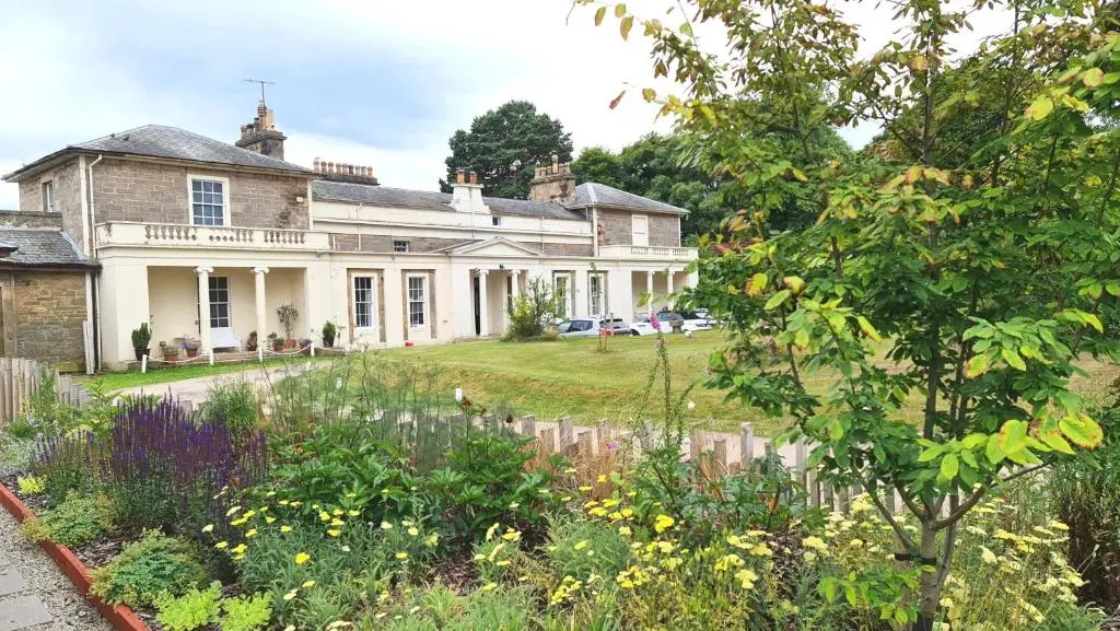 a house with a garden in front of it at East Wing Apartment in Elgin in Elgin