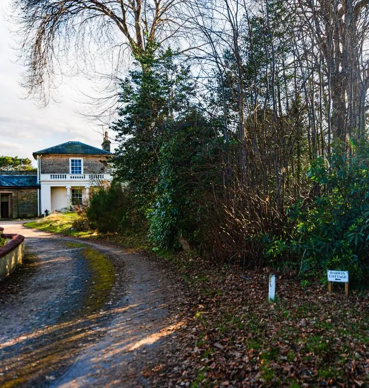 a road leading to a house with a sign on it at East Wing Apartment in Elgin in Elgin