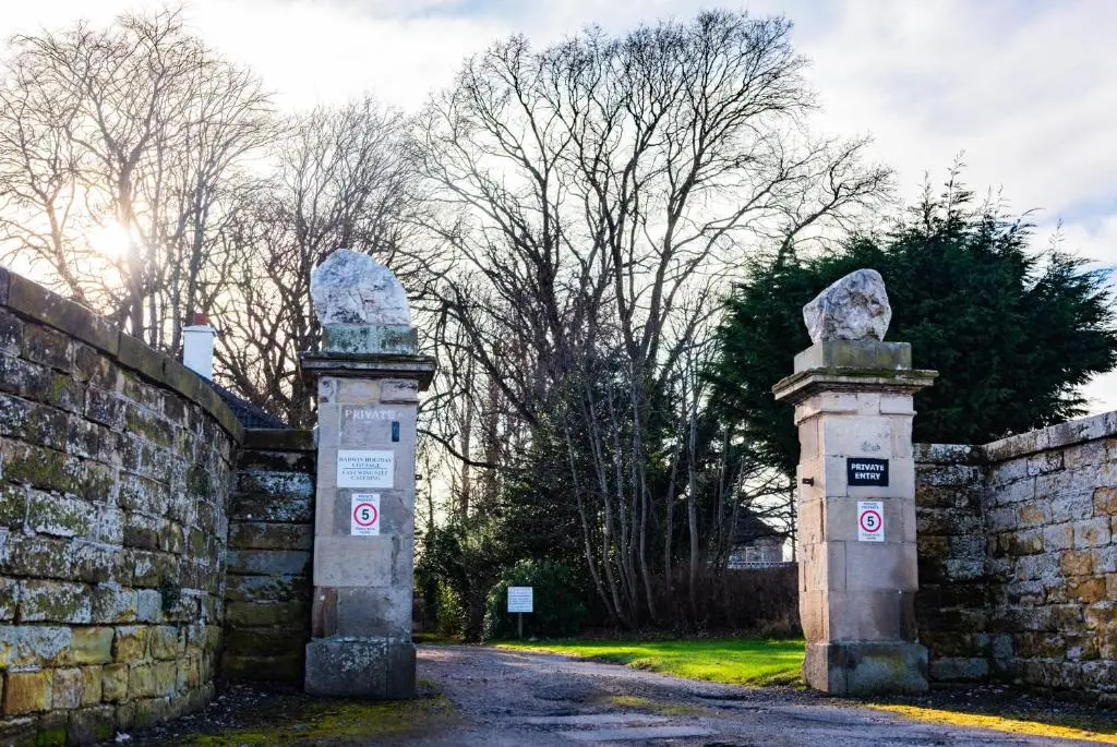 two stone monuments in front of a stone wall at East Wing Apartment in Elgin in Elgin
