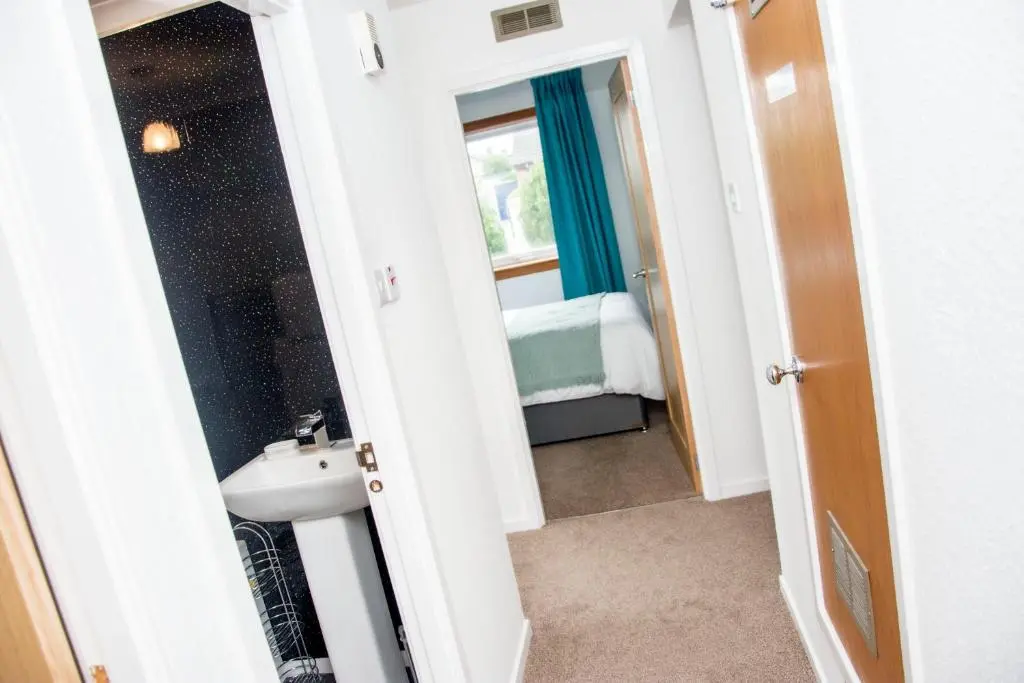 a bathroom with a white sink and a mirror at Distillery Apartment 1 in Elgin