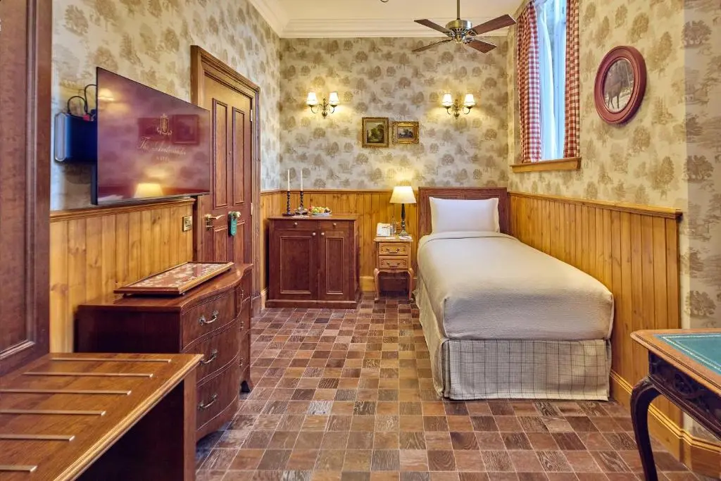a bedroom with a bed and a sink in a room at The Ambassador Hotel in Inverness