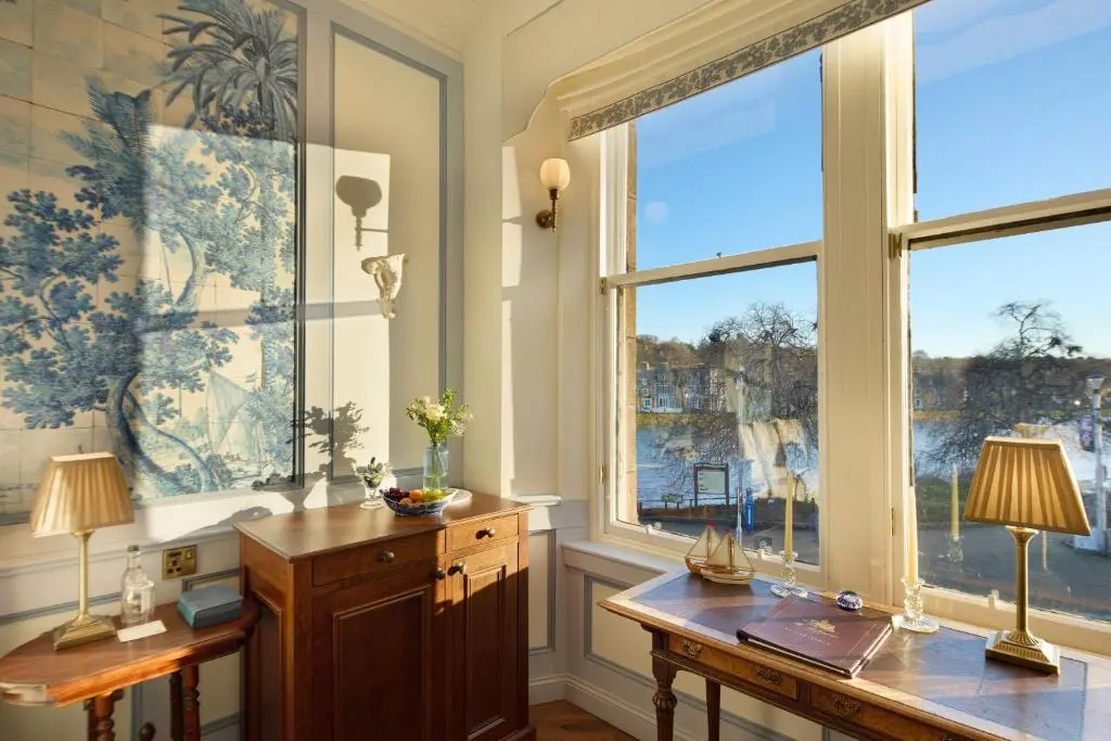 a home office with a desk and two windows at The Ambassador Hotel in Inverness