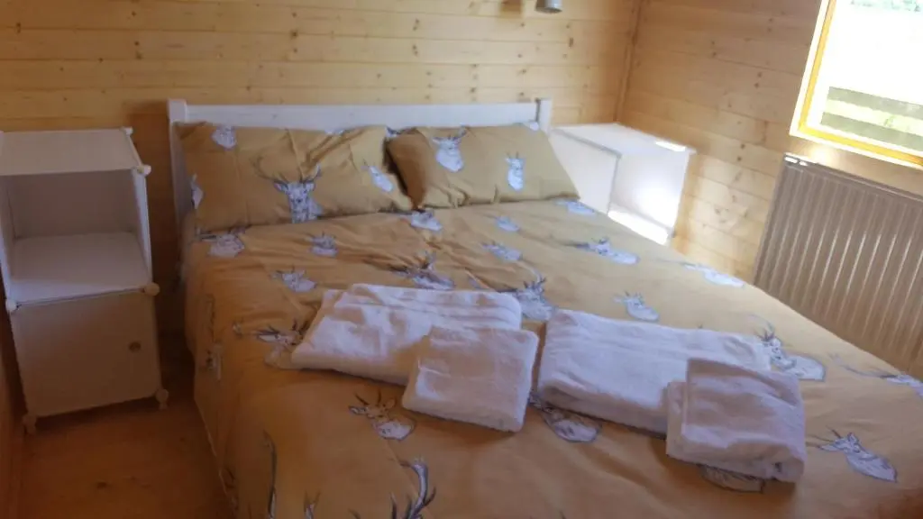 a bedroom with a bed with towels on it at Canterra Cottage in Tain