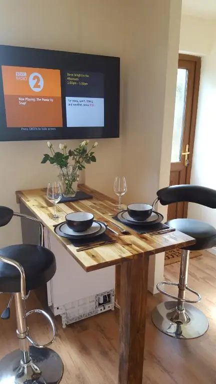 a wooden table with two empty wine glasses on it at Canterra Cottage in Tain